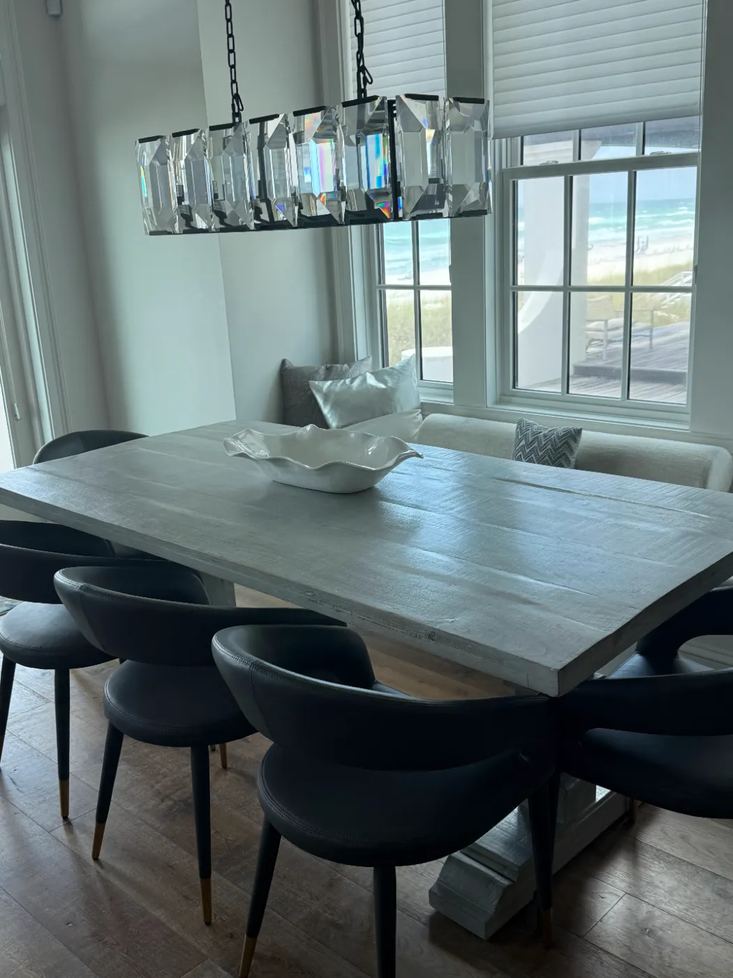 Beach house dining room with ocean view, table and chairs cleaned by Alyne Oliver Cleaning in Panama City Beach, FL