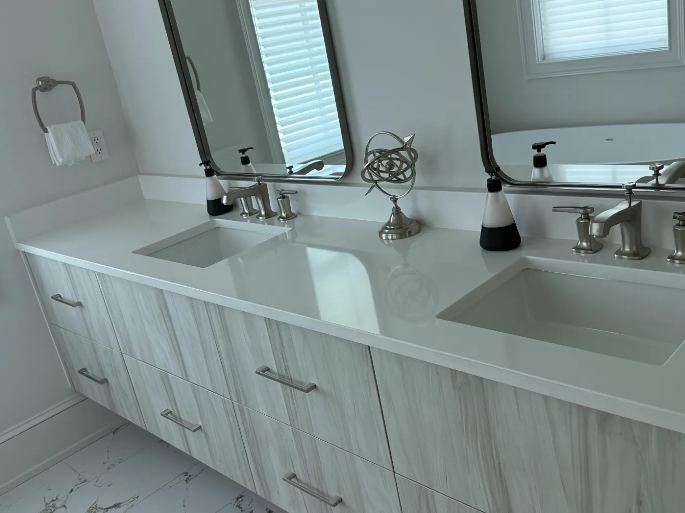 White quartz double vanity and mirrors polished by Alyne Oliver Cleaning in Panama City Beach, FL